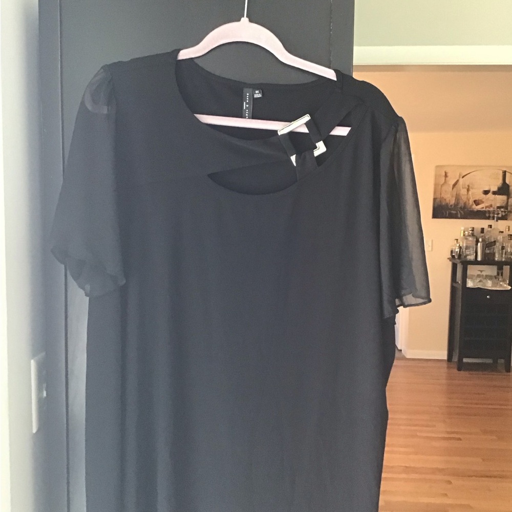 Beautiful summer blouse with buckle in front and sheer sleeves.